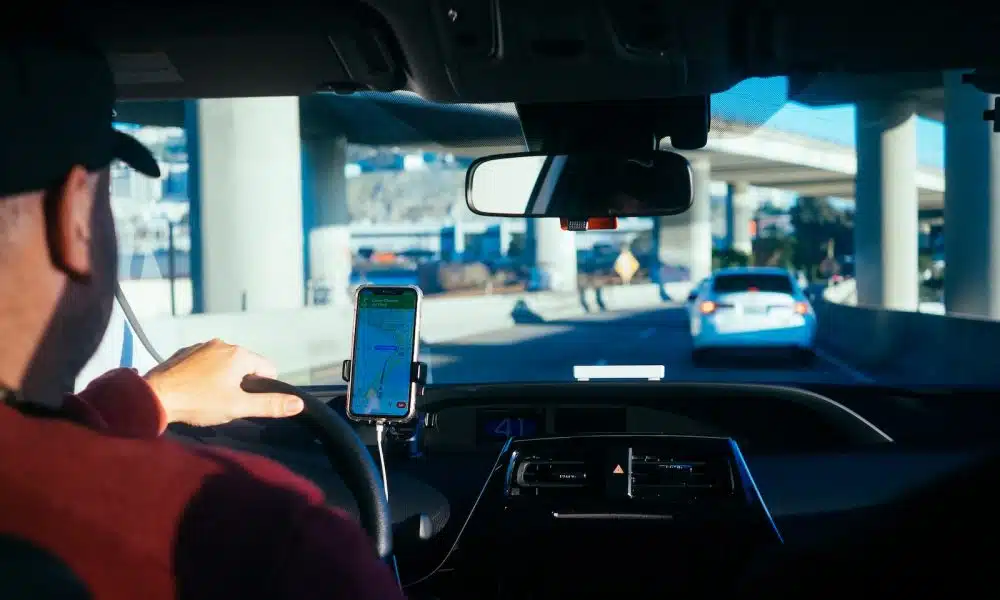 person holding iphone 6 inside car