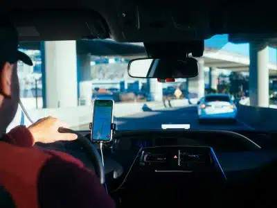 person holding iphone 6 inside car