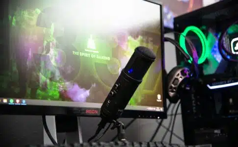 black microphone beside black flat screen computer monitor